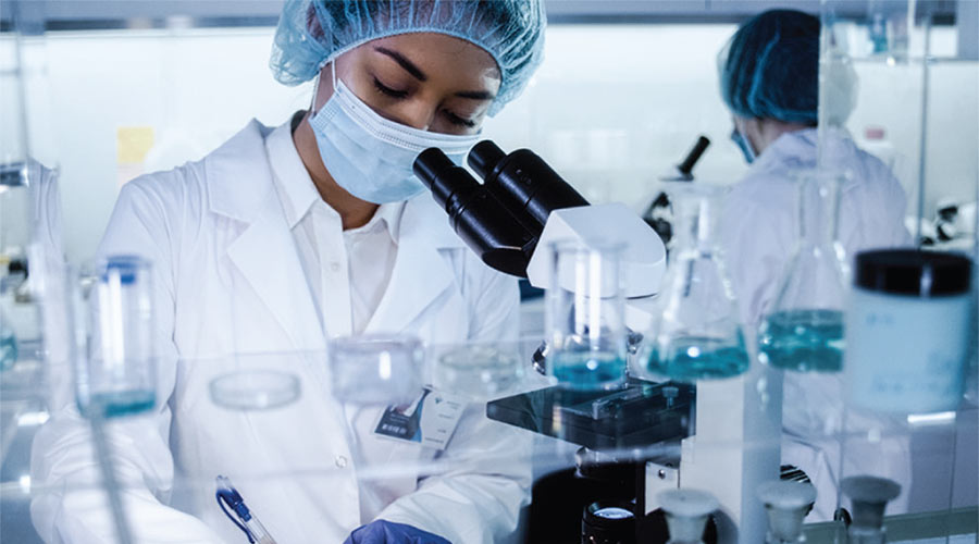 Photo of of female scientist making notes in a lab