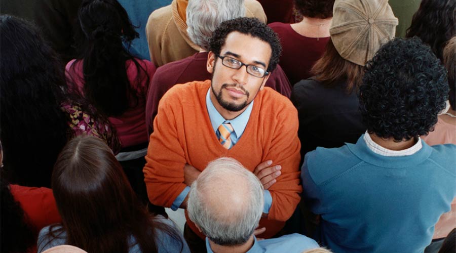 Photo of a man standing in a crowd
